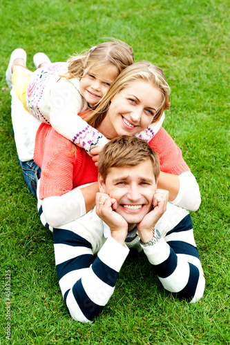 Husband, wife and child piled on each other