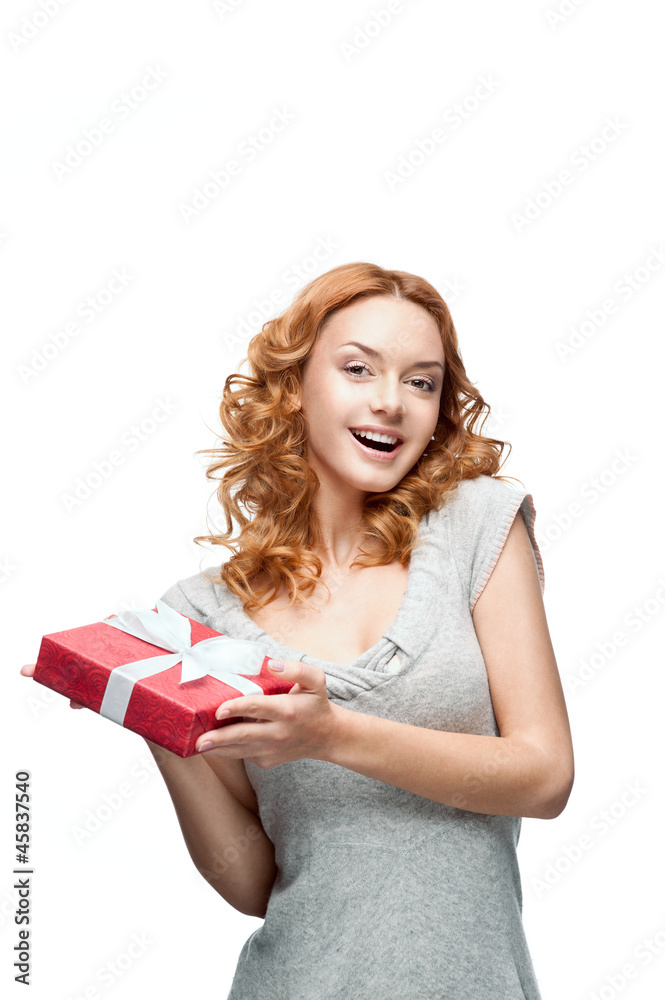 young red-haired happy smiling girl holding gift young red-haired happy smiling girl holding gift