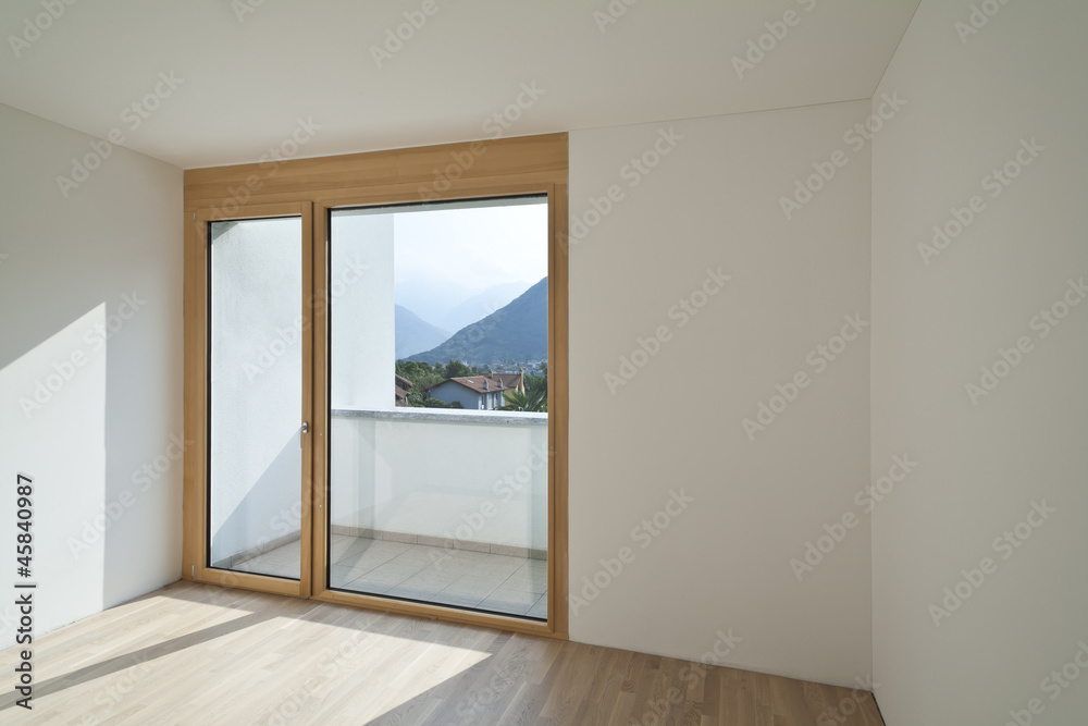 empty room with window and parquet empty room with window and parquet