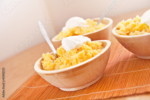 polenta corn traditional food cooking in wooden dish