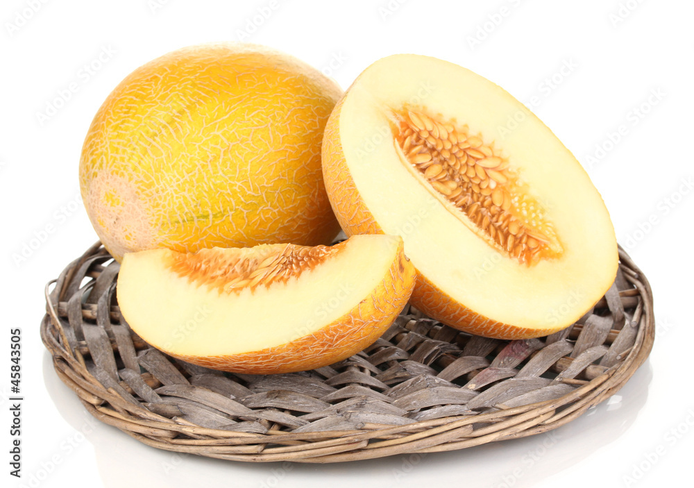 Ripe melons on wicker cradle isolated on white Ripe melons on wicker cradle isolated on white