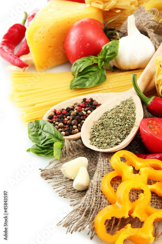 Pasta spaghetti  vegetables and spices  isolated on white