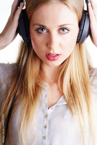 nice blond woman listening to the music on headphones