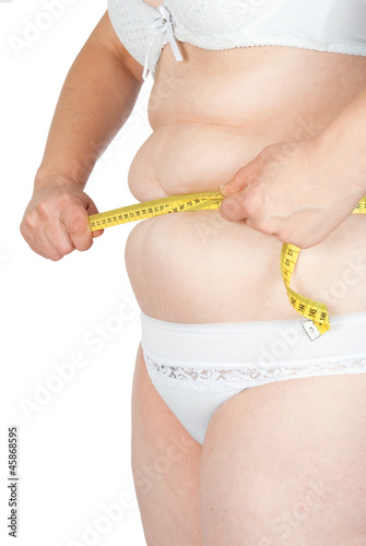 Fat woman measuring her stomach