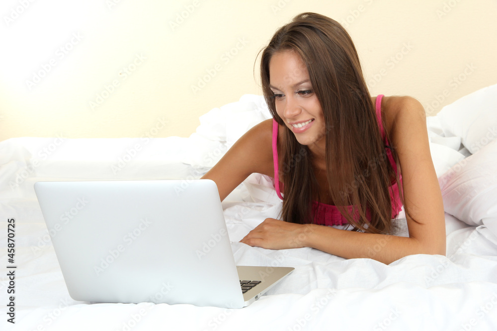 young beautiful woman with notebook in bed young beautiful woman with notebook in bed