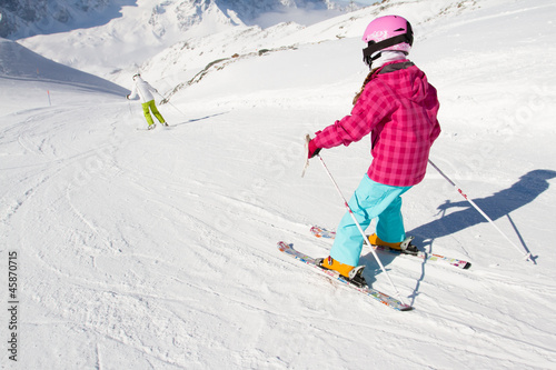 Skiing, winter, ski lesson - kid skier on ski run