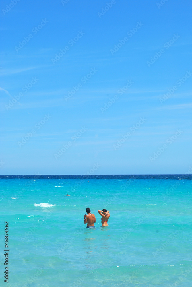 Young couple in the sea of Sardinia
