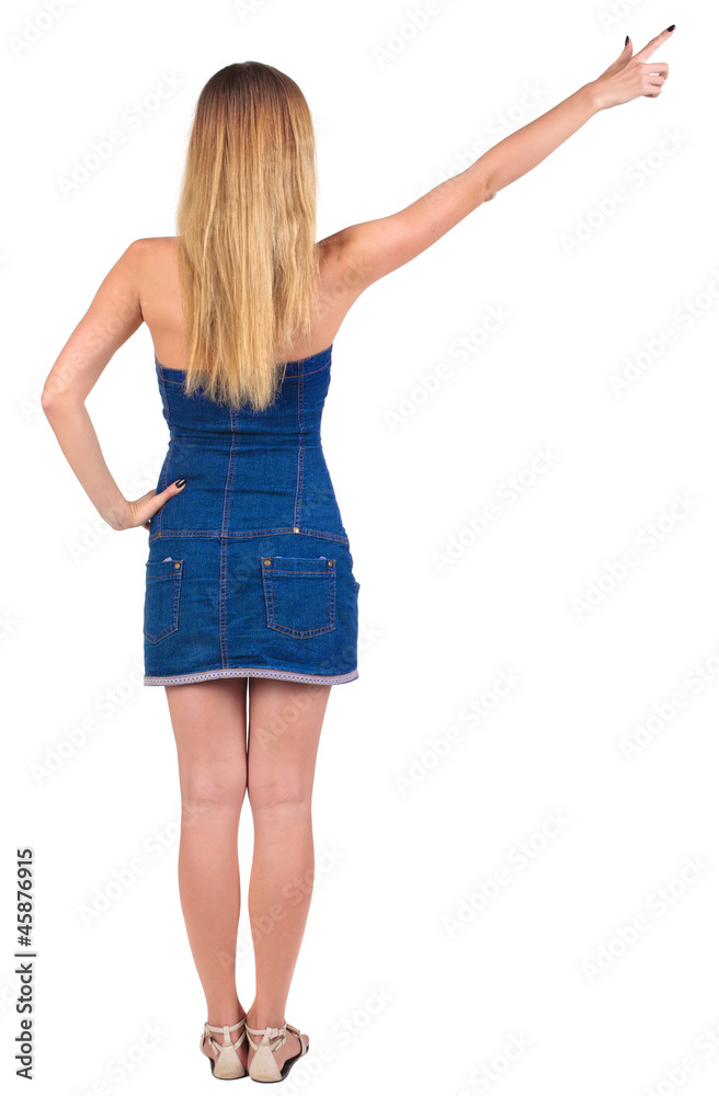 back of view beautiful young woman in jeans dress pointing at w back of view beautiful young woman in jeans dress pointing at w