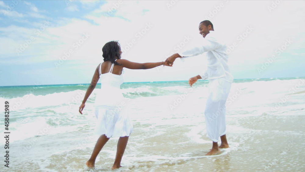 African American parent dancing together daughter on beach African American parent dancing together daughter on beach