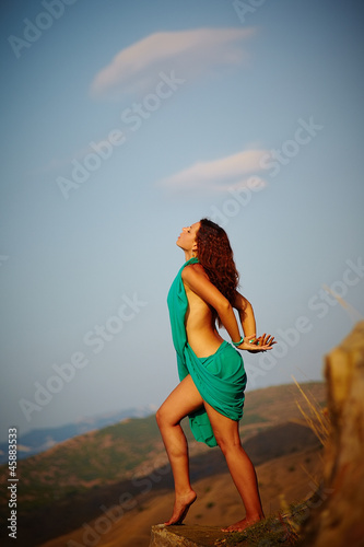 Beautiful girl standing on a precipice