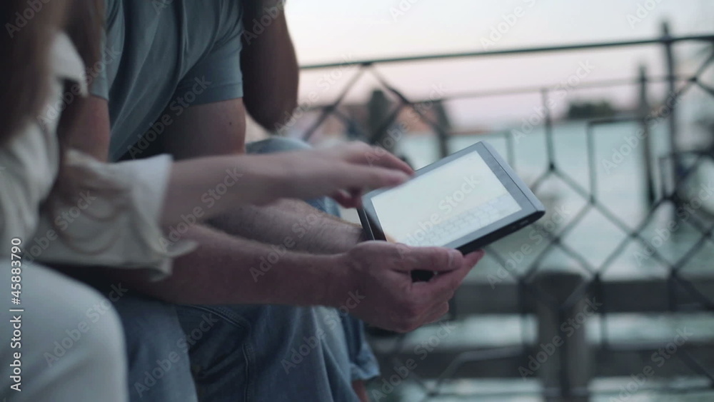 Three friends with tablet computer, outdoor, steadicam shot Three friends with tablet computer, outdoor, steadicam shot