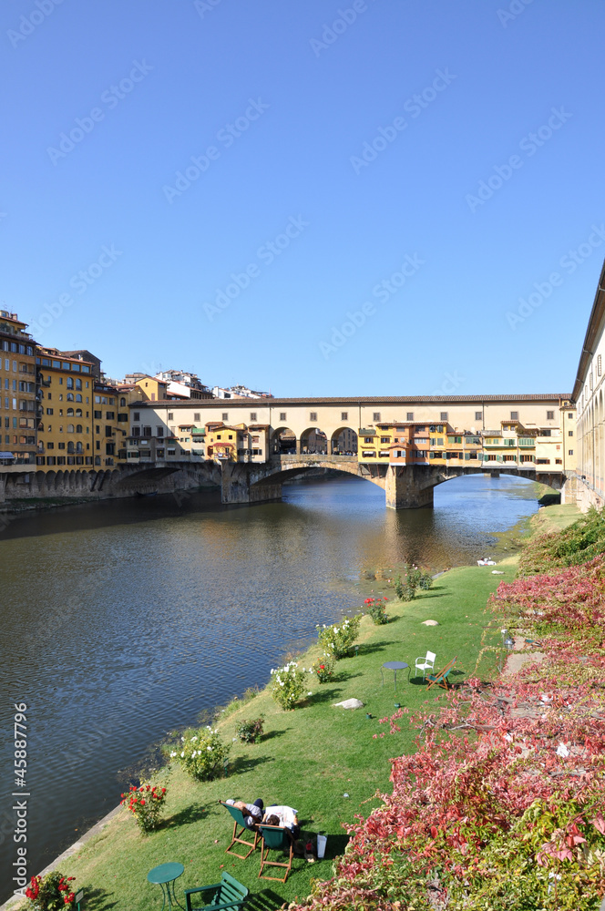 relax in Florence in front of Ponte Vecchio bridge