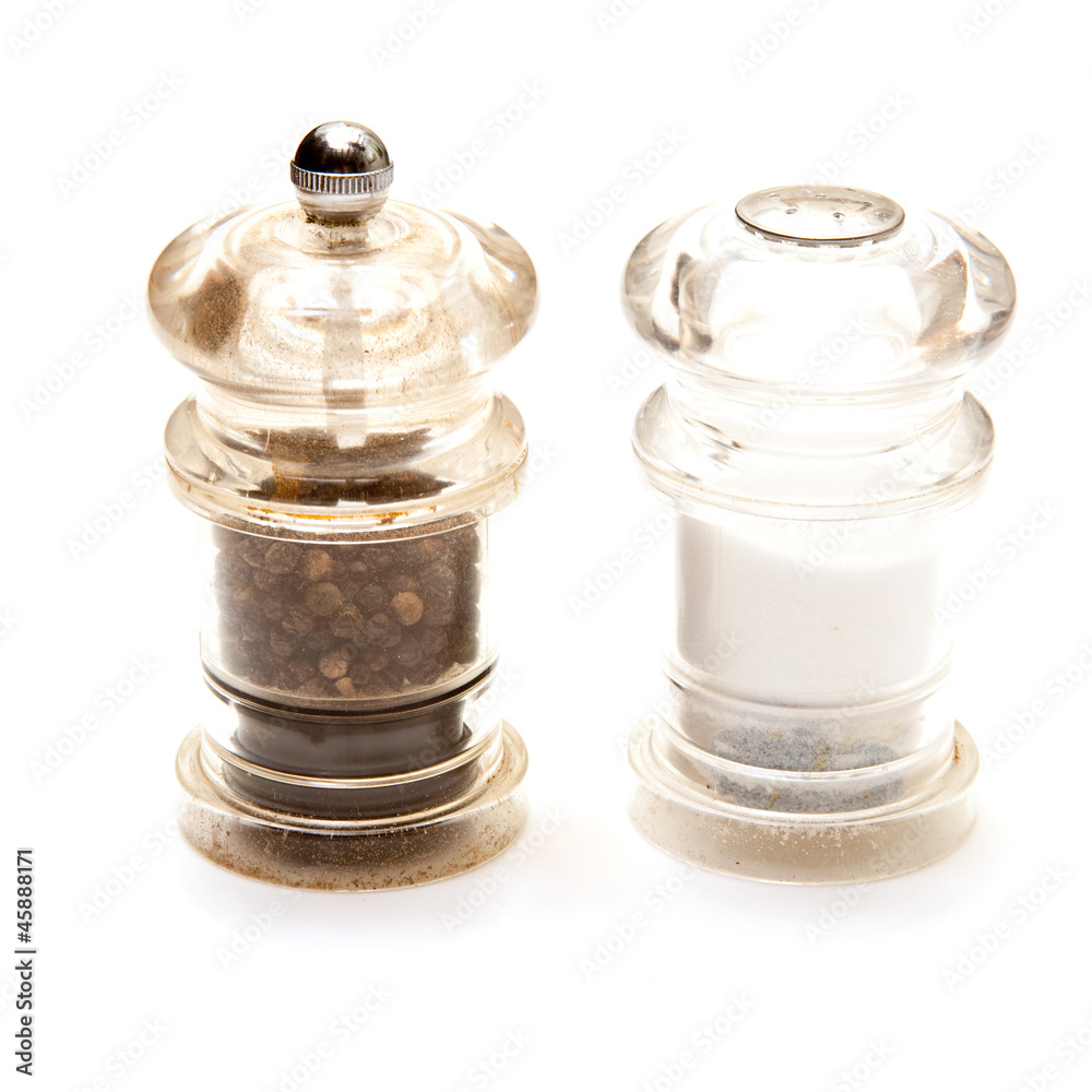 Salt and Pepper grinders isolated on a white studio background. Salt and Pepper grinders isolated on a white studio background.