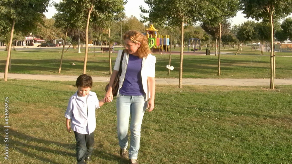 Mother and son walking in the park steady cam shot Mother and son walking in the park steady cam shot