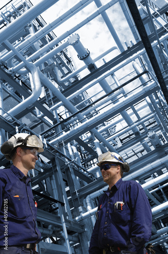 oil engineers with giant pipeline constructions