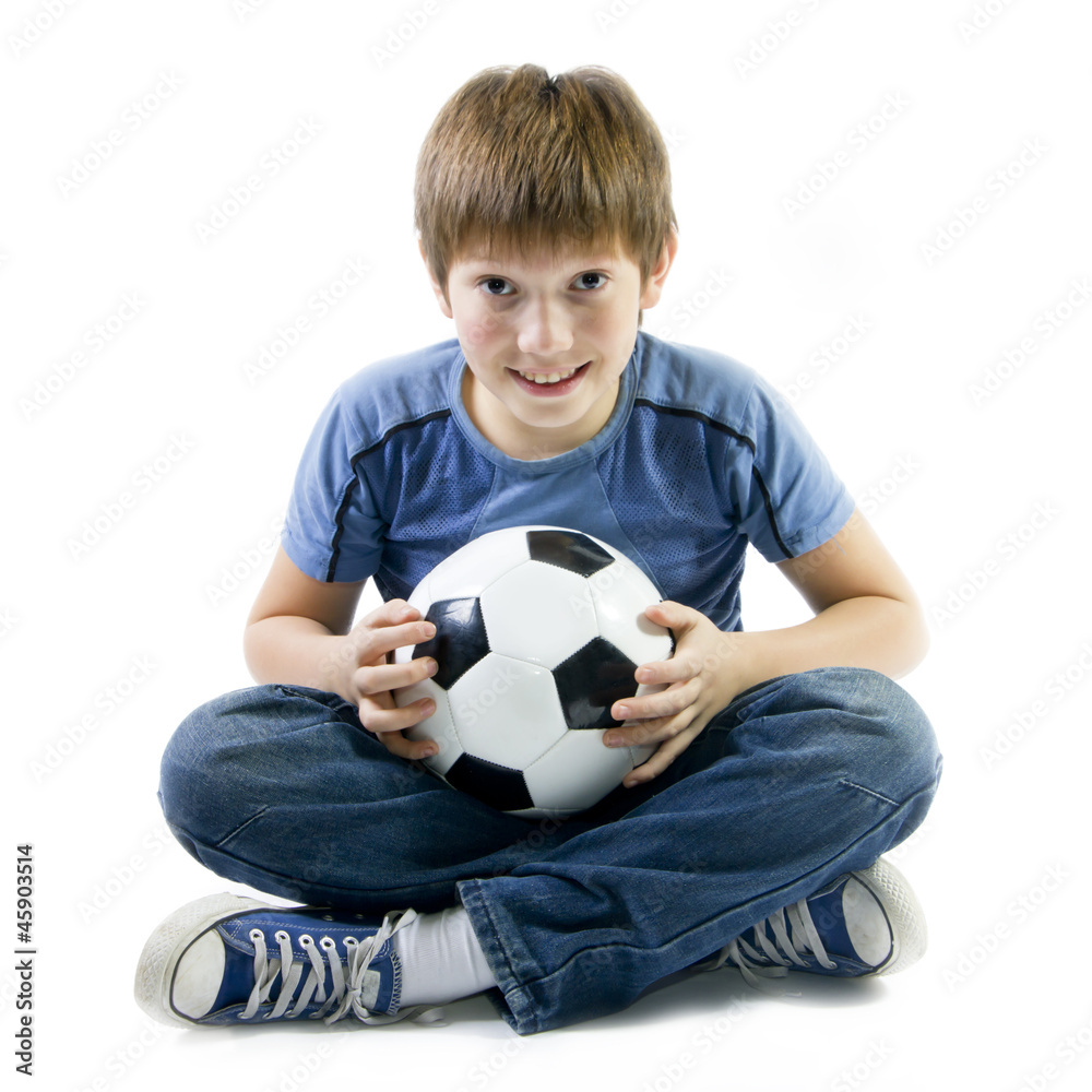 Boy sitting on floor with football ball Boy sitting on floor with football ball
