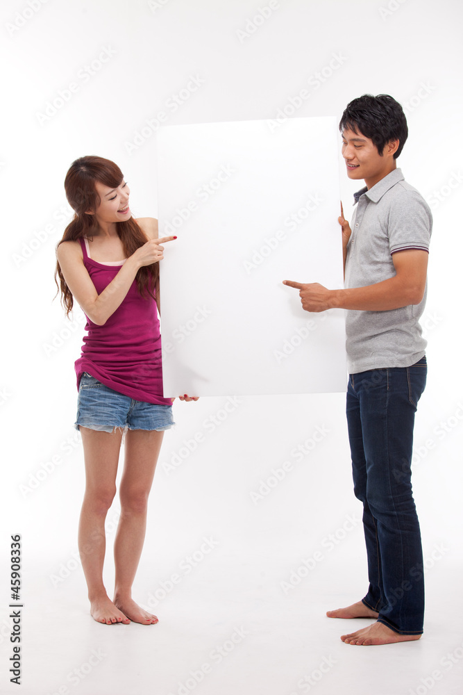 Young couple take white panel isolated on white background. Young couple take white panel isolated on white background.