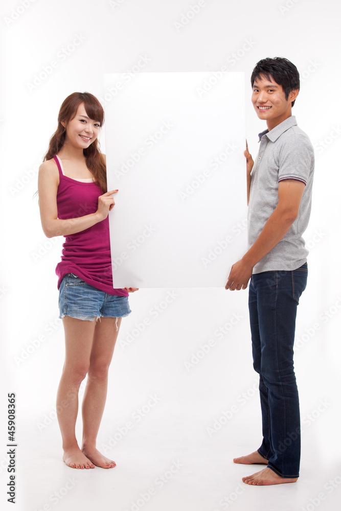Young couple take white panel isolated on white background. Young couple take white panel isolated on white background.