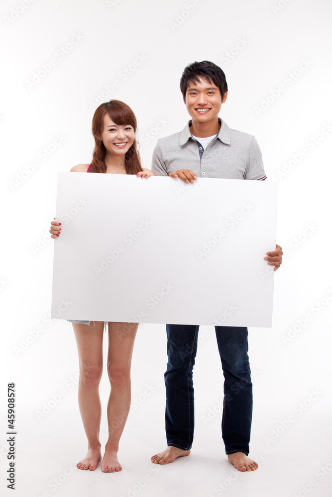 Young couple take white panel isolated on white background. Young couple take white panel isolated on white background.