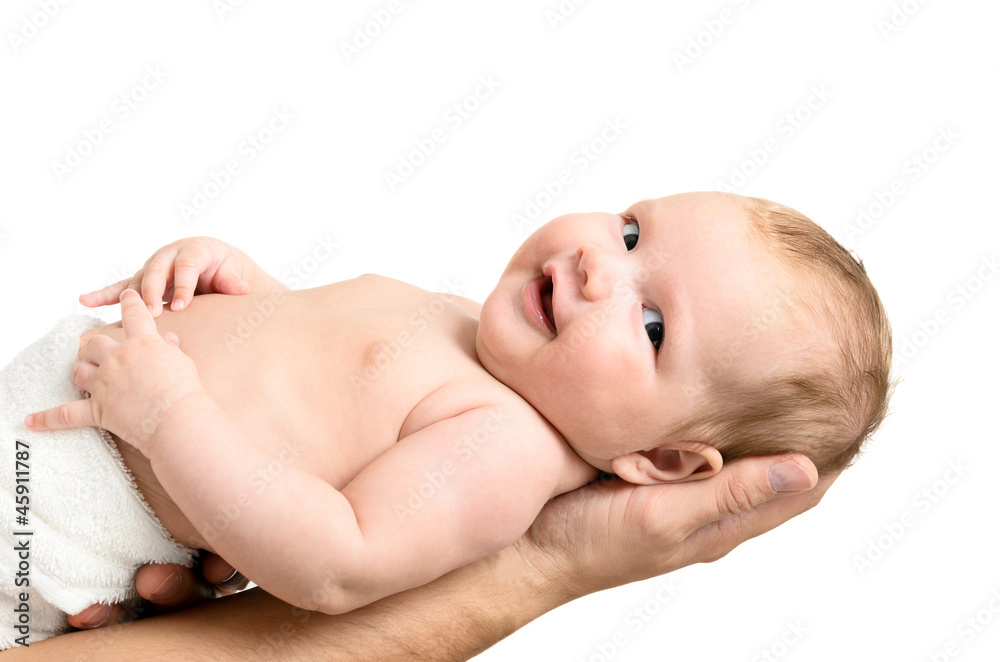 Little baby girl held carefully by father's hands
