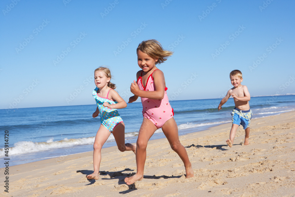 Three Children Running Along Beach