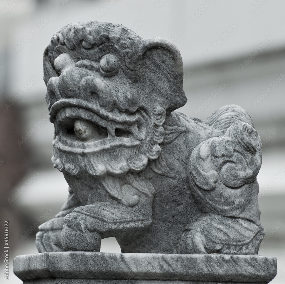 Obraz premium Stone Lion sculpture, symbol of protection & power in Oriental A