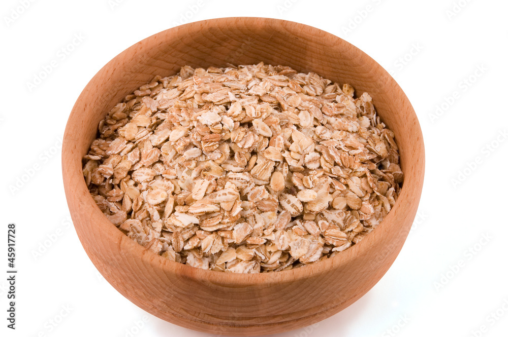 A bowl of oat flakes on white A bowl of oat flakes on white