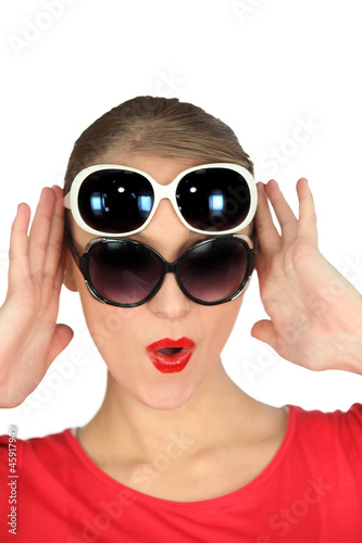 Woman wearing two pairs of sunglasses