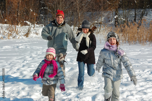 Happy family have fun, playing with snow on winter vacation