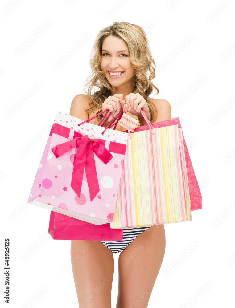 seductive woman in bikini with shopping bags