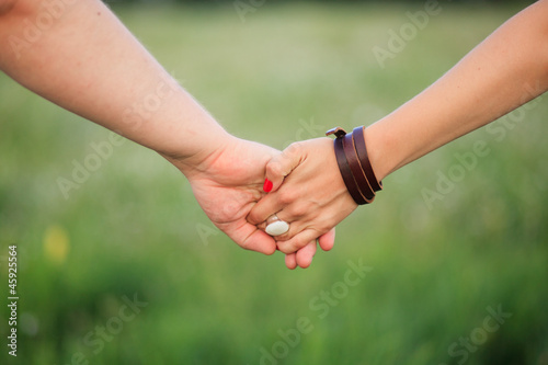 Couple Holding Hands on a field