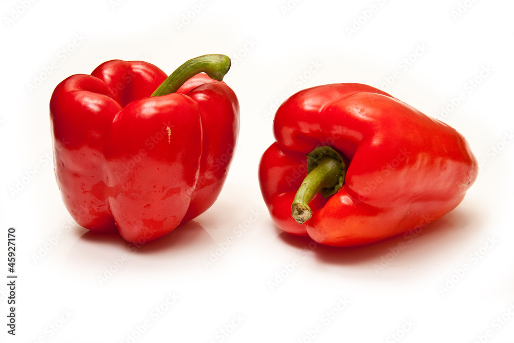 Red bell peppers on a  white studio background.