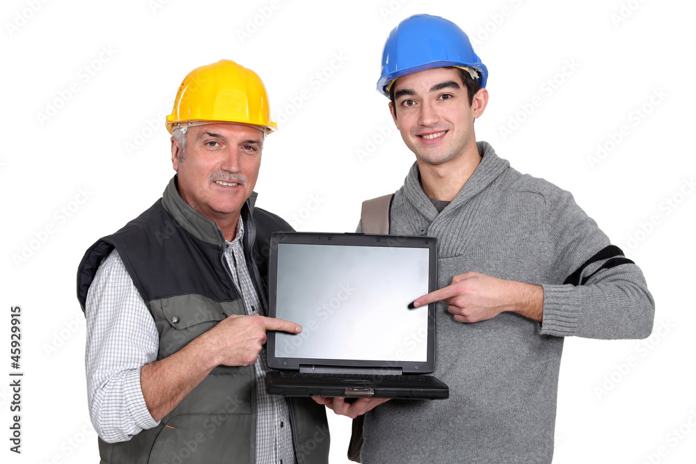 Builder and youth worker pointing at laptop Builder and youth worker pointing at laptop