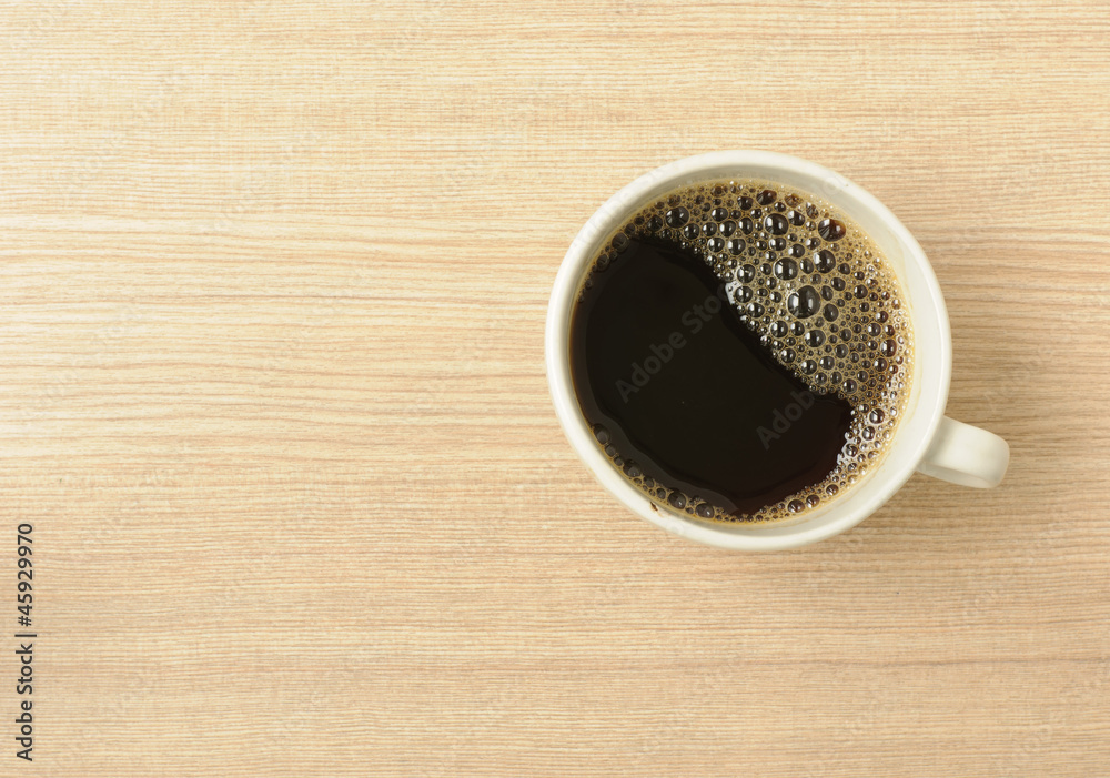 Fresh Black Coffee in a White Ceramic Cup on a Wooden Table Fresh Black Coffee in a White Ceramic Cup on a Wooden Table