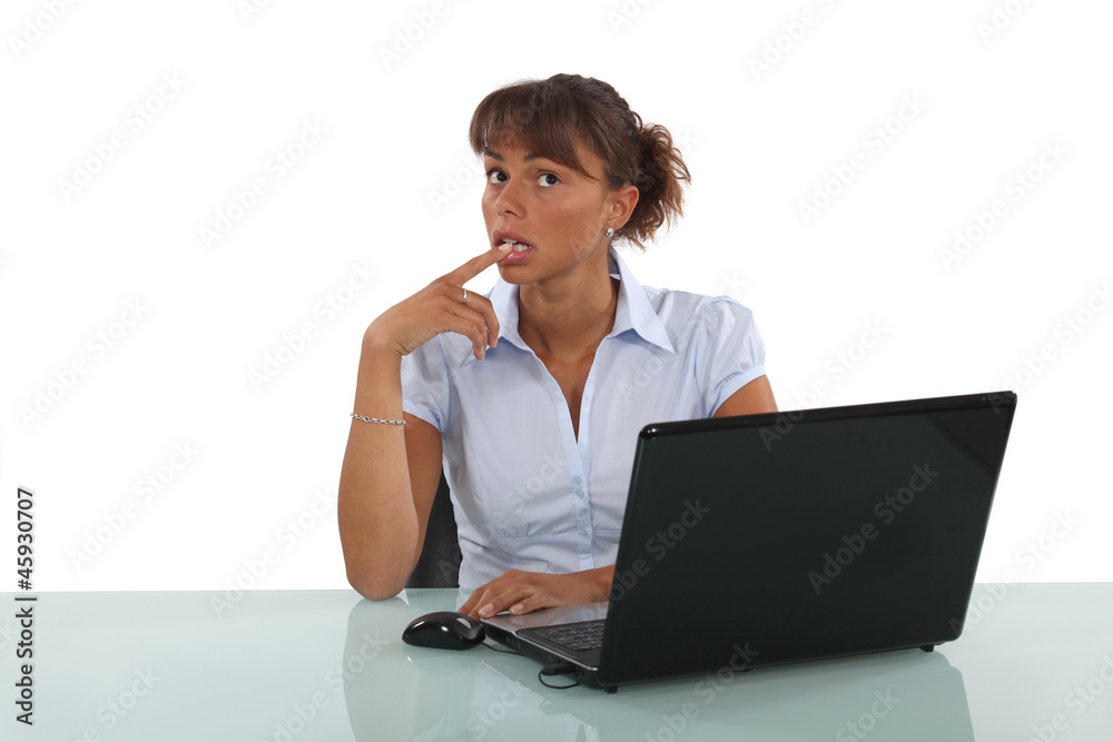 businesswoman sitting at her desk and thinking businesswoman sitting at her desk and thinking
