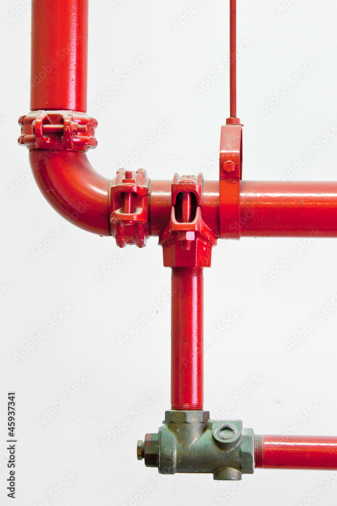 Red water pipes against a white wall Red water pipes against a white wall