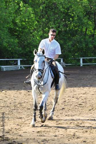 Jockey riding horse on hippodrome