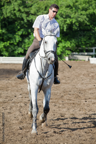Jockey in glasses riding horse on hippodrome © Pavel Losevsky