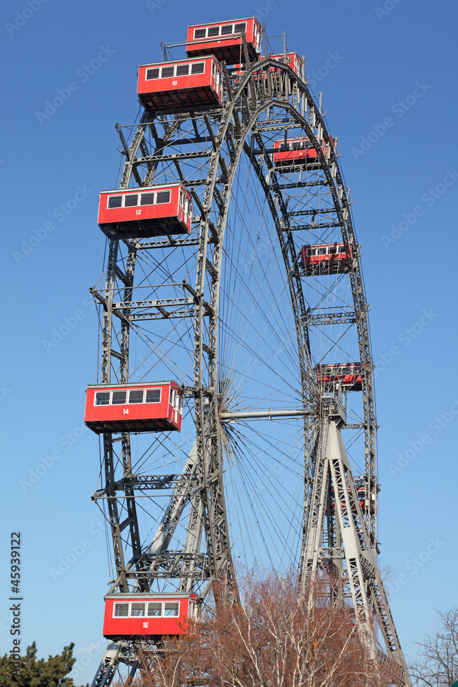 Fototapeta premium ferris wheel with red cabines in Prater park in Vienna, Austria