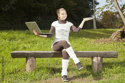 Cute girl in dilemma what to use, laptop or Tablet PC