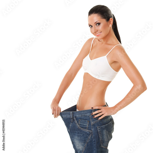 Funny woman shows her weight loss by wearing an old jeans, isola © Dmytro Sunagatov
