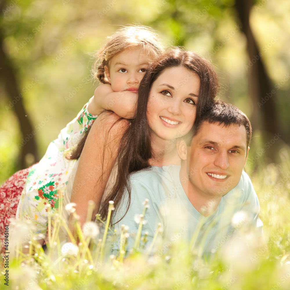 Happy mother, father and daughter in the park Happy mother, father and daughter in the park