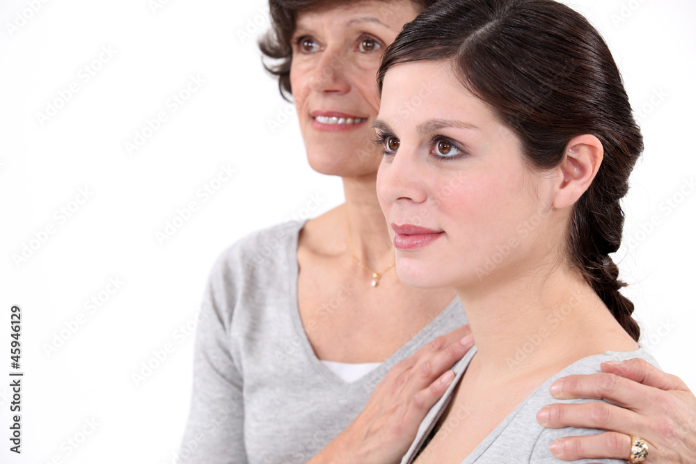 Mother putting her hands on her daughter's shoulders Mother putting her hands on her daughter's shoulders