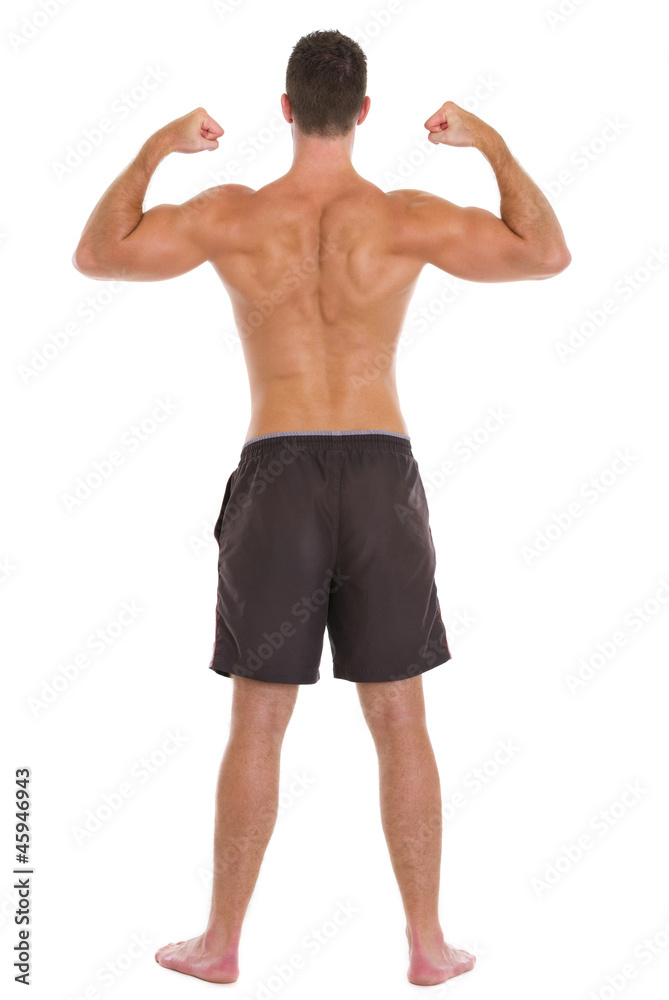 Strong man sports man showing muscular back Strong man sports man showing muscular back