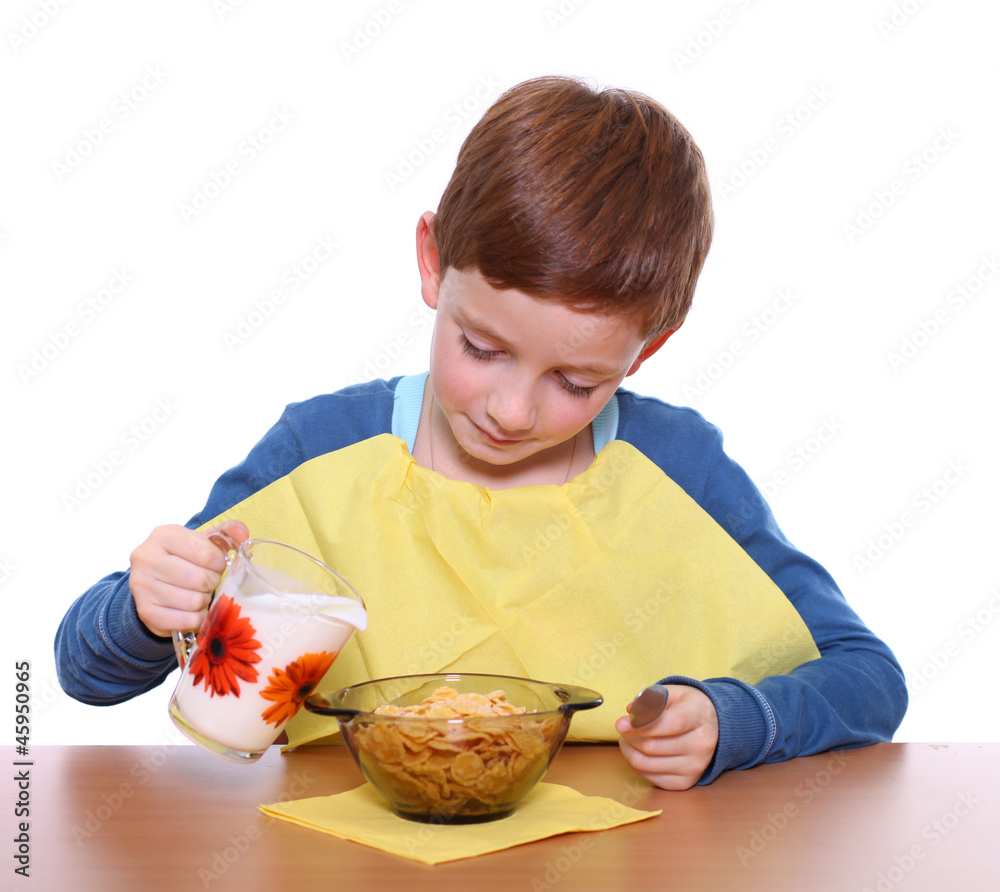 Little boy breakfast isolated over white background Little boy breakfast isolated over white background