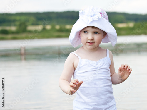 Cute little girl playing in a lake