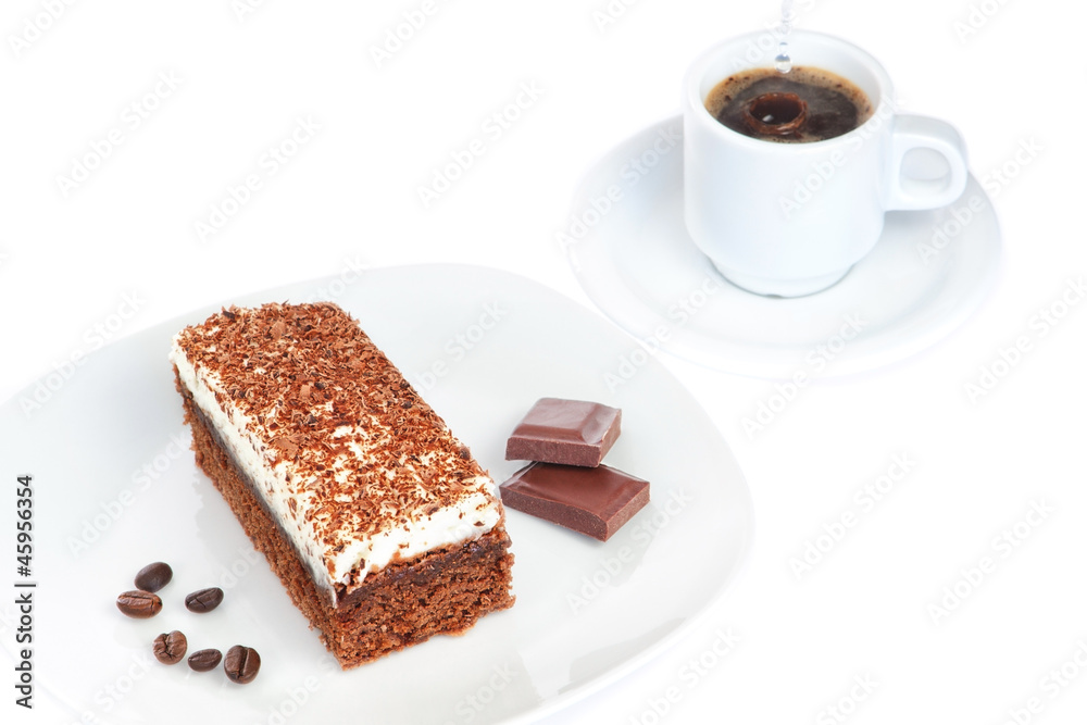 Breakfast of cake pieces of chocolate and coffee. On a white bac Breakfast of cake pieces of chocolate and coffee. On a white bac
