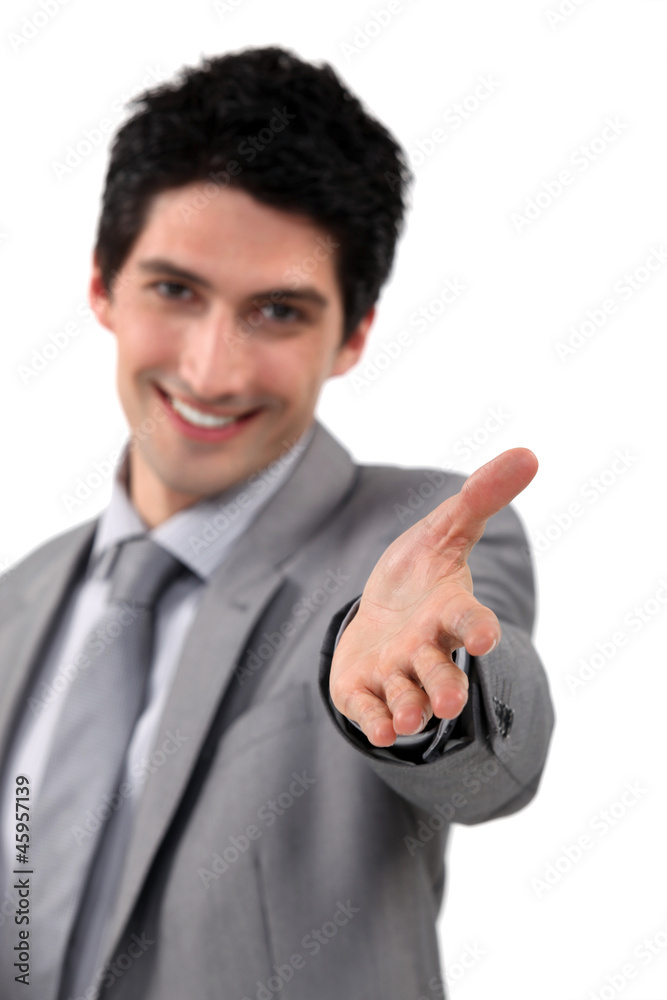 Friendly businessman offering to shake hands Friendly businessman offering to shake hands