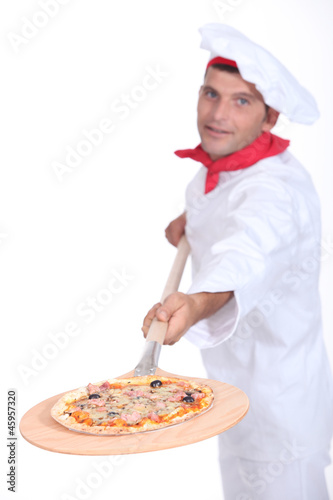 Pizza chef with a wooden peel