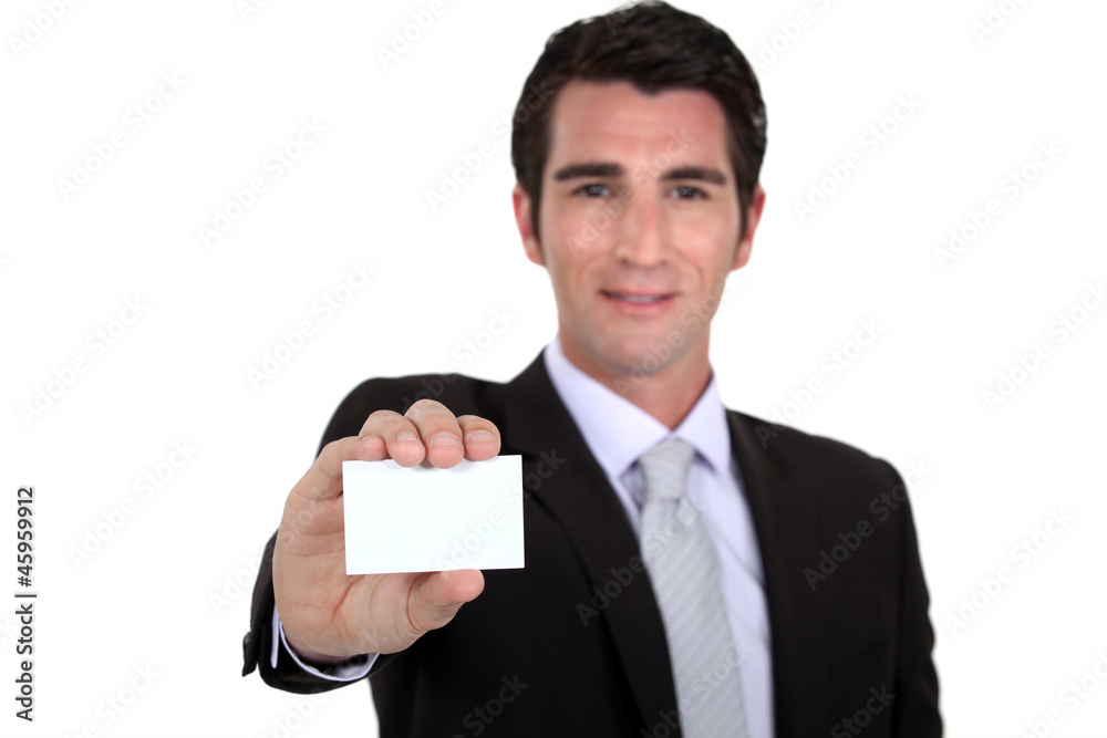 Confident businessman flaunting business card Confident businessman flaunting business card